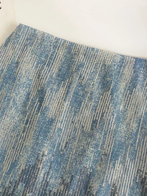 Light blue sequin mini skirt with diagonal stripe pattern and distressed denim look.