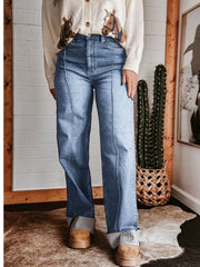 Light blue denim wide-leg jeans with buttoned pockets and contrast stitching.