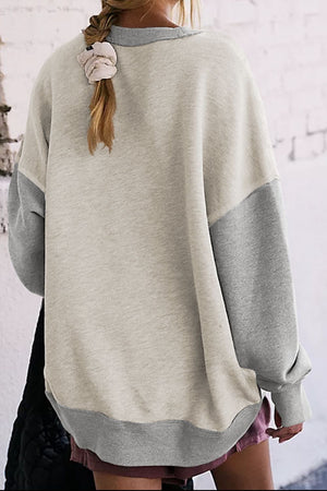 Crewneck sweatshirt with colorblock sleeves in light gray and tan, casual relaxed fit.