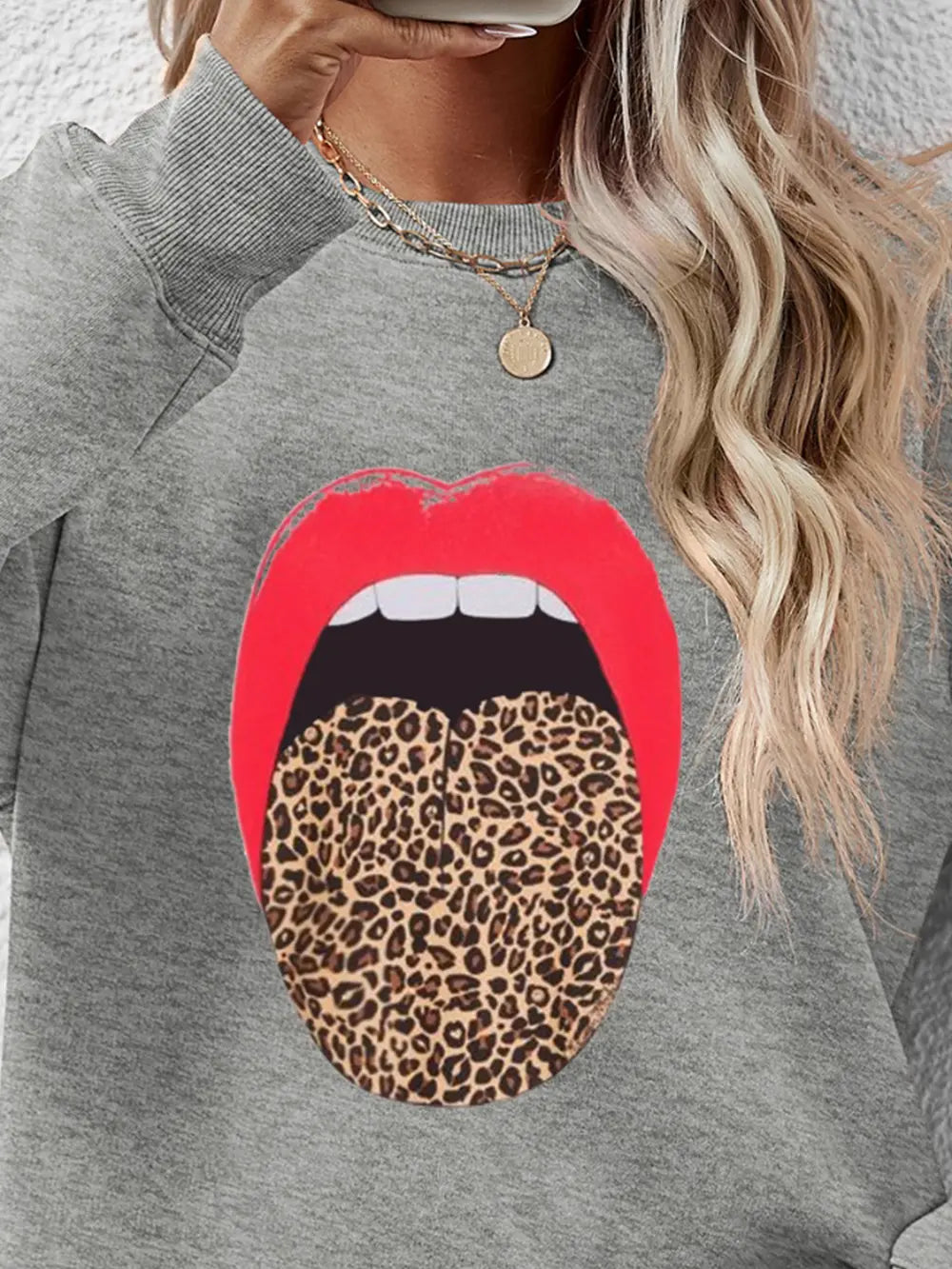 Gray sweatshirt with red lips and leopard tongue graphic.