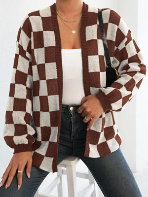 Checkerboard knit cardigan in brown and white with balloon sleeves and an open front.