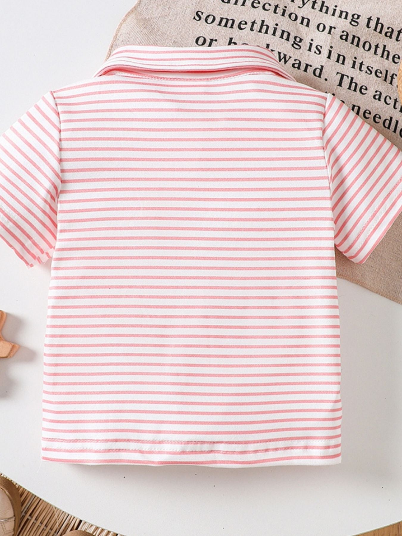 Pink striped cotton polo shirt for baby with classic collar and short sleeves.