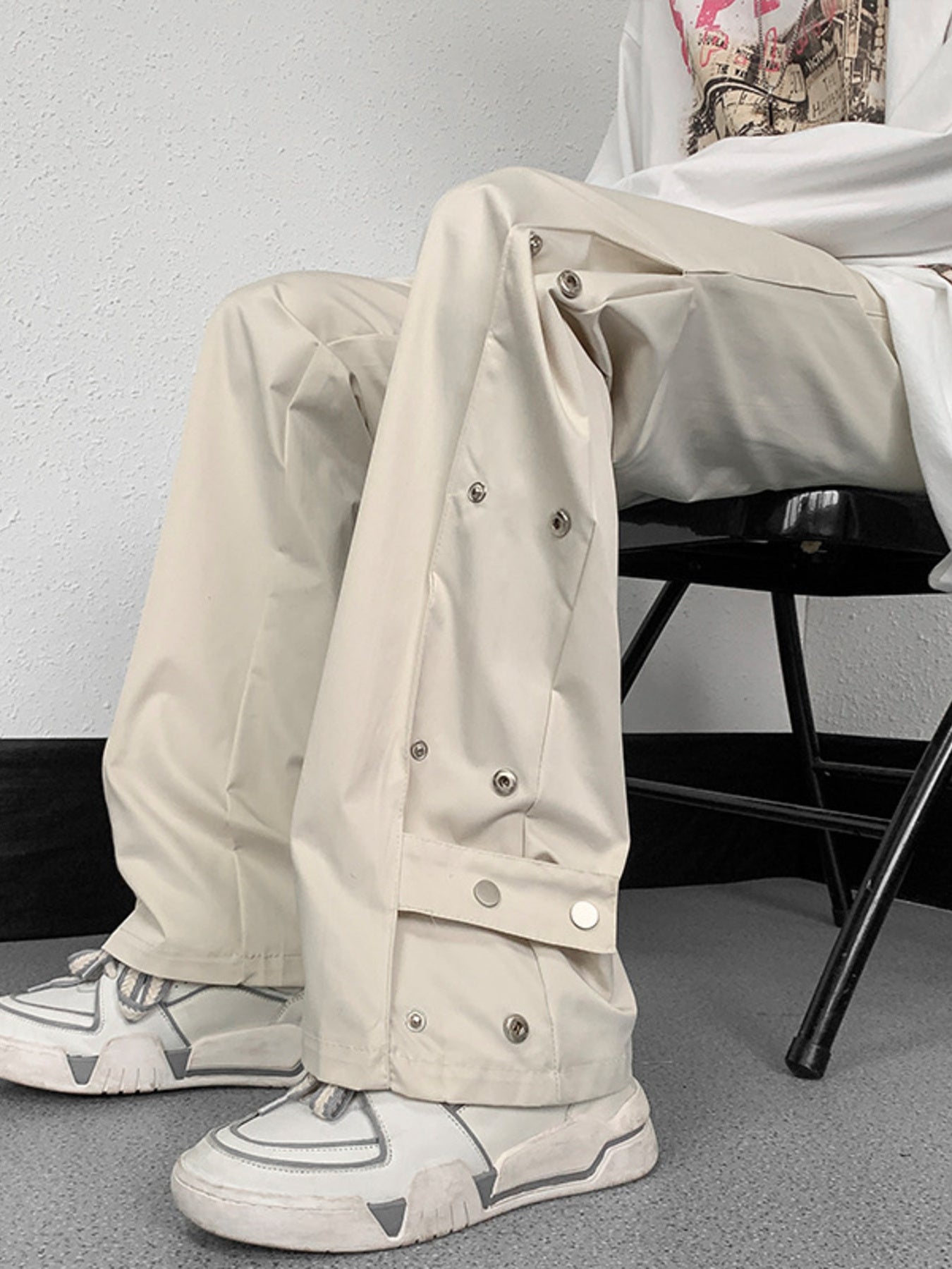 Men's beige snap button loose fit sweatpants with adjustable waist.