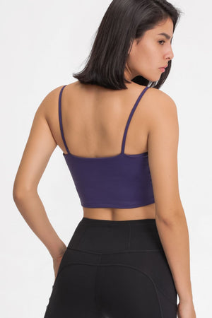 Purple scoop neck crop tank top with thin spaghetti straps.