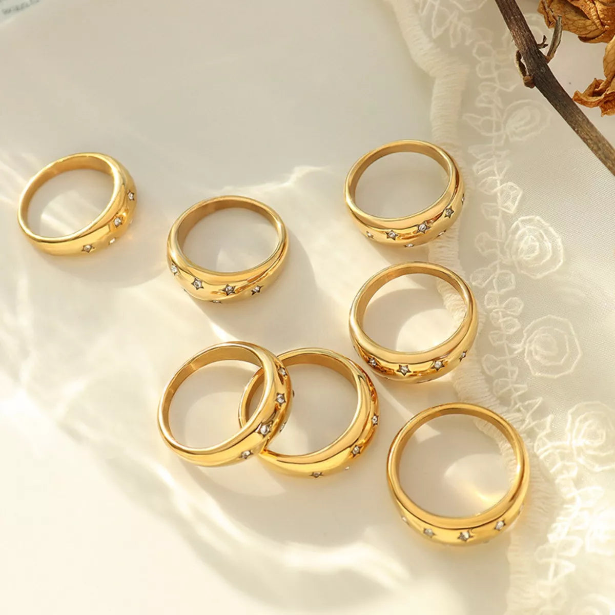 Gold rings with star-shaped zircon accents
