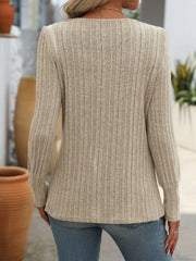 Ribbed knit top in beige with long sleeves and button detail on the side.