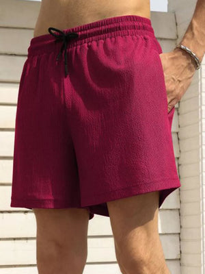 Burgundy drawstring chino shorts with textured fabric and pockets.