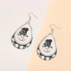 Festive snowman layered drop earrings with buffalo check pattern and black hat.