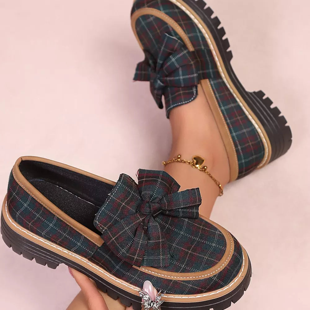 Plaid chunky loafers with bow accent and tan trim, featuring a lug sole.