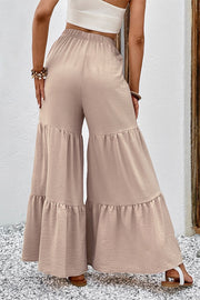 Tiered ruffle palazzo trousers in tan with a textured fabric and wide leg.