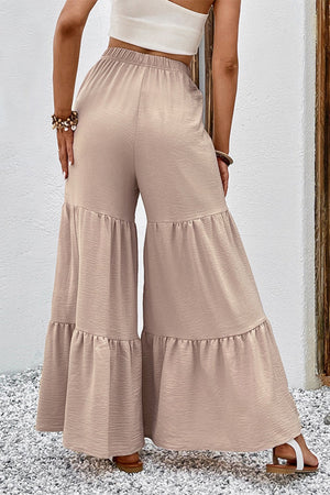 Tiered ruffle palazzo trousers in tan with a textured fabric and wide leg.