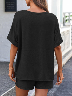 Black relaxed fit tee with cuffed sleeves and matching shorts.