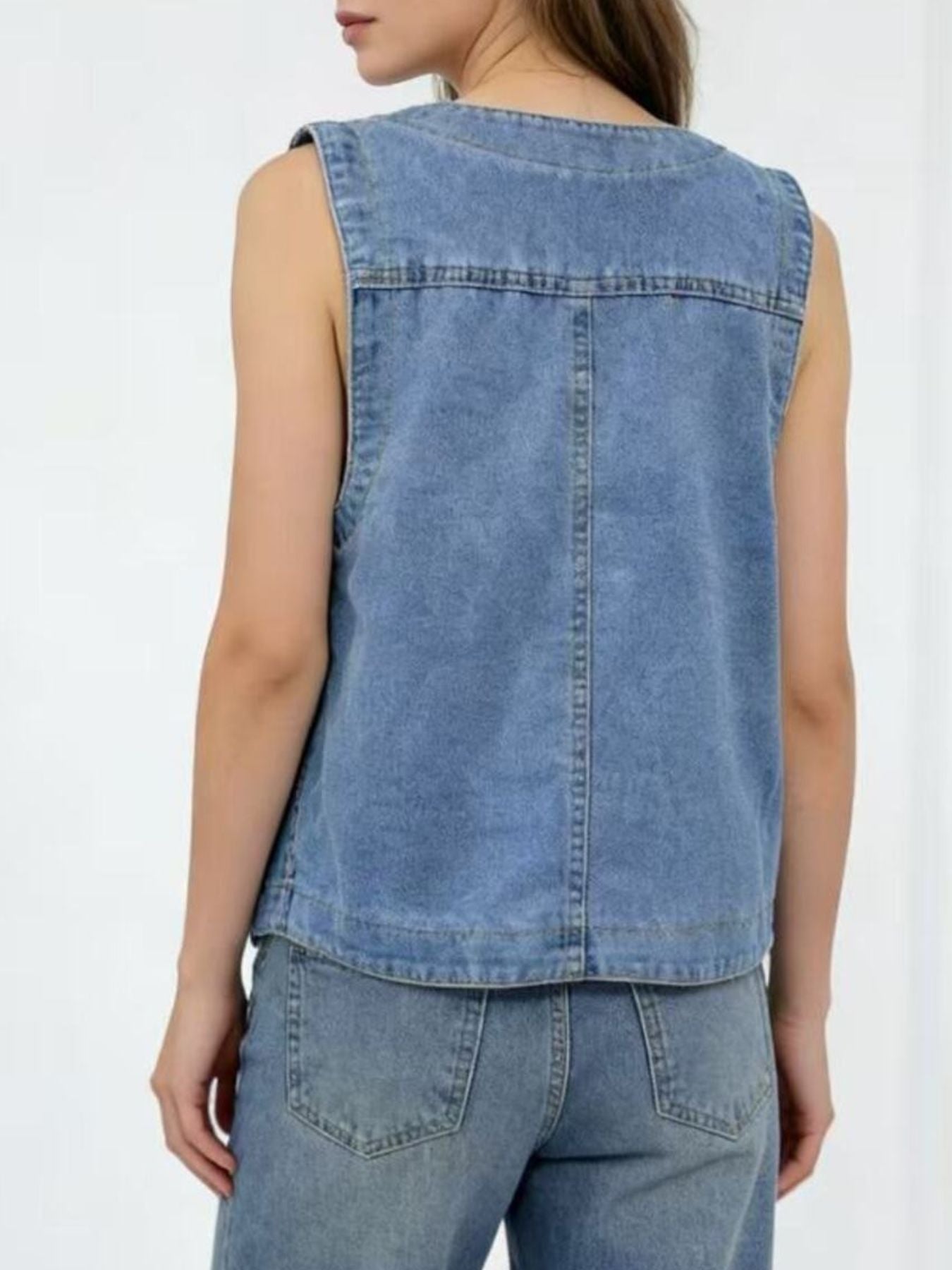Light blue denim button-down vest with brass buttons, cropped length