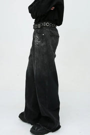 Faded panel wide-leg jeans in dark denim with distressed detailing and a raw hem.