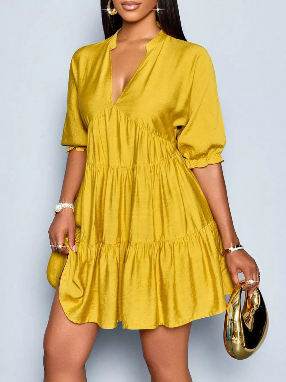 Yellow tiered mini dress with notched V-neck and short puff sleeves.