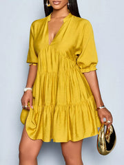 Yellow tiered mini dress with notched V-neck and short puff sleeves.