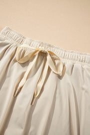 Beige skort with elastic waist and tie detail