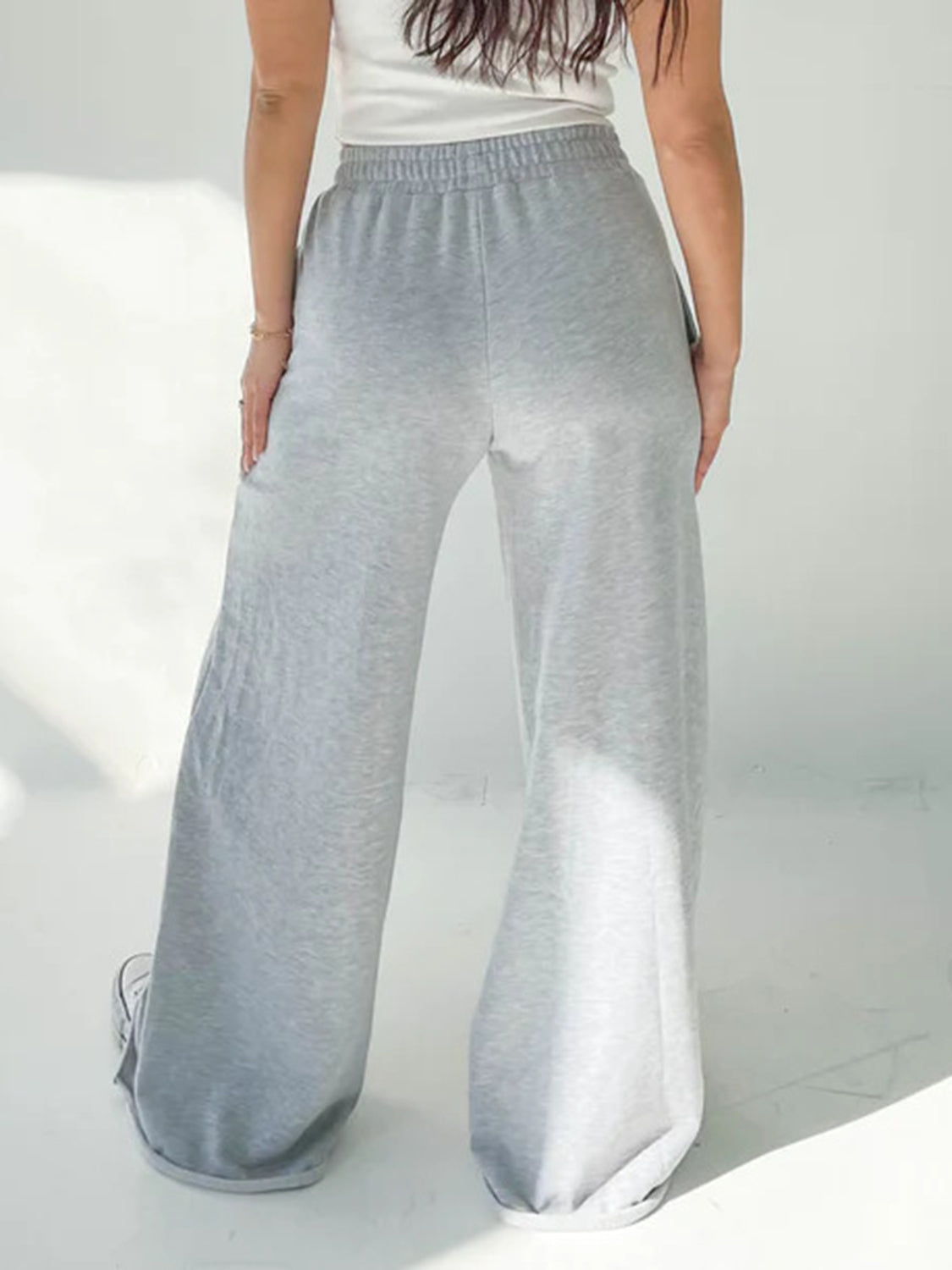 Wide-leg lounge pants in light gray with an elastic waistband and cuffed hems.