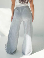 Wide-leg lounge pants in light gray with an elastic waistband and cuffed hems.