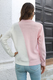 Diagonal knit sweater in white and blush pink acrylic with colorblock design.