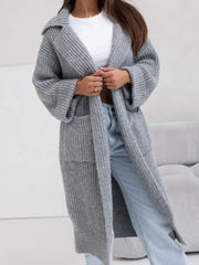 Oversized gray knit lapel cardigan with pockets and wide sleeves, styled with jeans.
