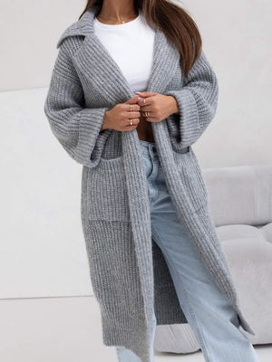Oversized gray knit lapel cardigan with pockets and wide sleeves, styled with jeans.