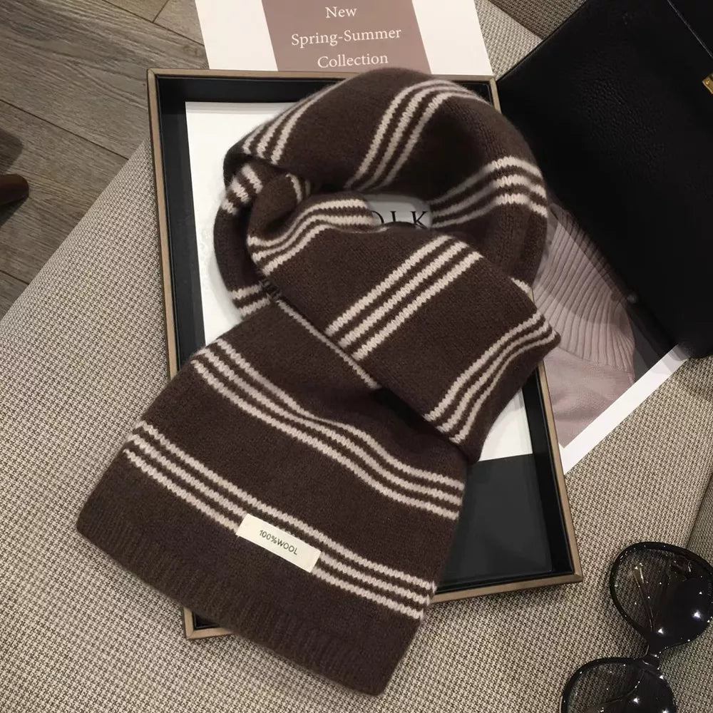 Brown wool knit scarf with off-white stripes and a 100% wool tag.