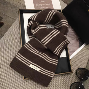 Brown wool knit scarf with off-white stripes and a 100% wool tag.