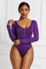 Plunge neckline zip-front bodysuit in violet with long sleeves.