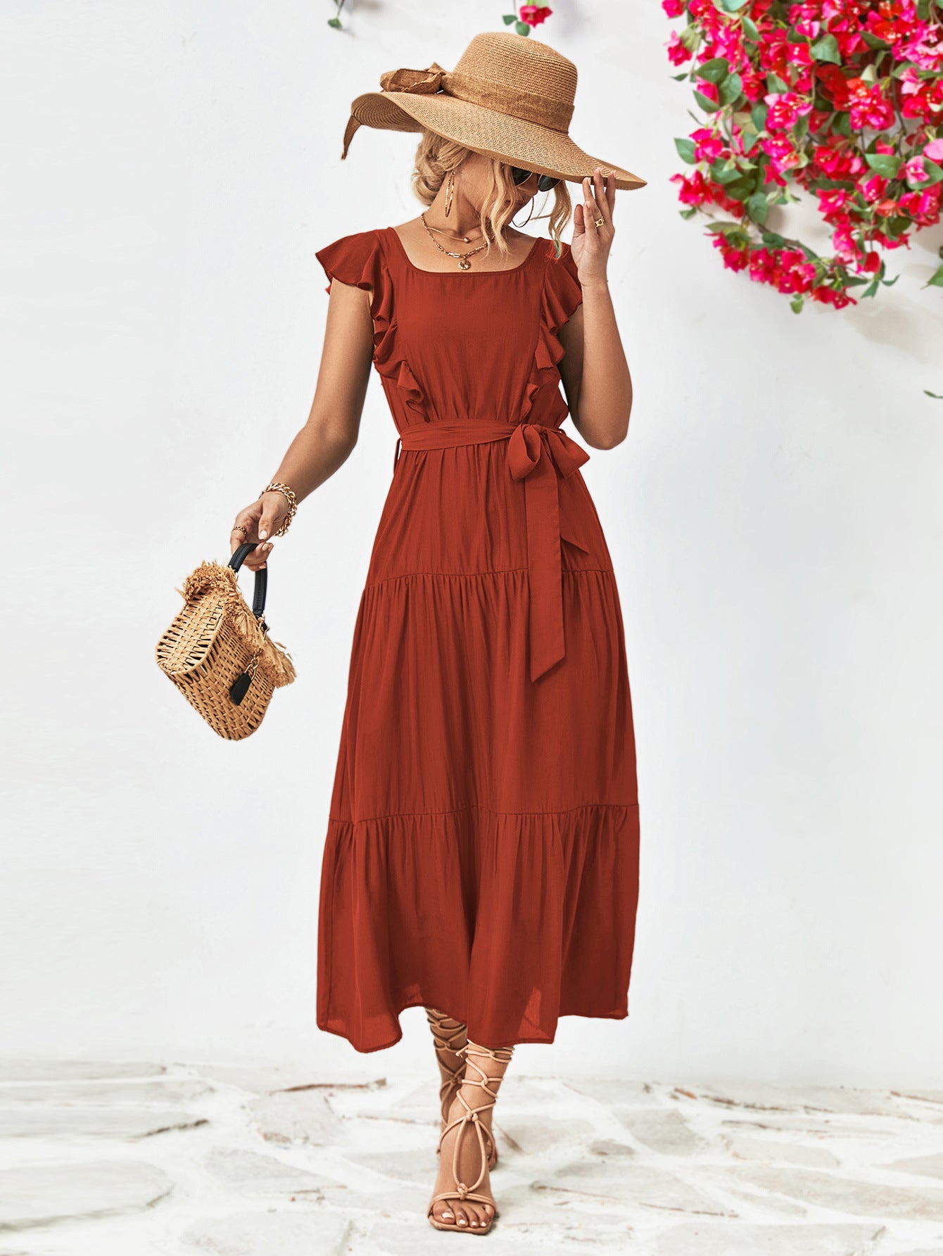 Tiered midi dress in brick red with flutter sleeves, square neck, and belted waist.