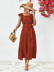 Tiered midi dress in brick red with flutter sleeves, square neck, and belted waist.