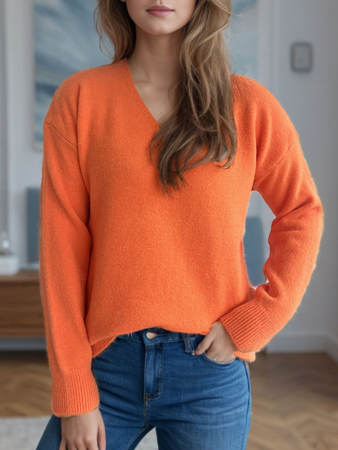 Orange V-neck knit sweater with ribbed hem and cuffs, relaxed fit