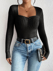 Black ribbed sweetheart neckline bodysuit with ruched detail and long sleeves.