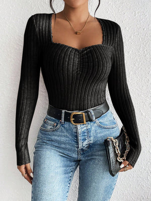 Black ribbed sweetheart neckline bodysuit with ruched detail and long sleeves.