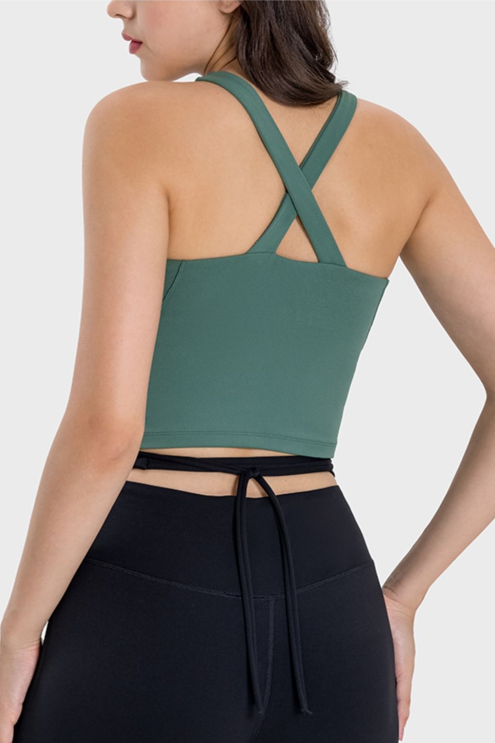 Teal keyhole halter cami crop top with crisscross back straps and tie waist detail.