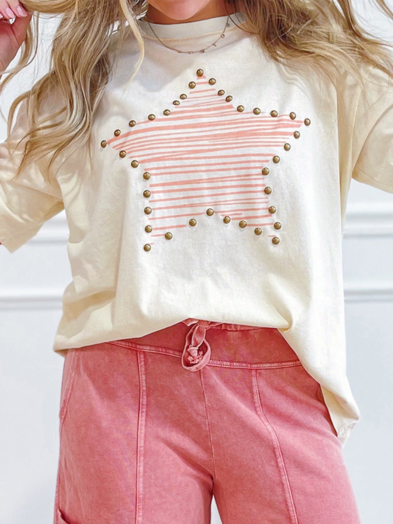 Cream t-shirt with pink striped star graphic and stud details, crew neck, long sleeves.