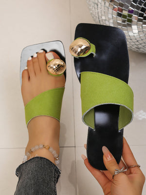 Chic square toe ring sandals in black with lime green asymmetric strap and gold accent.