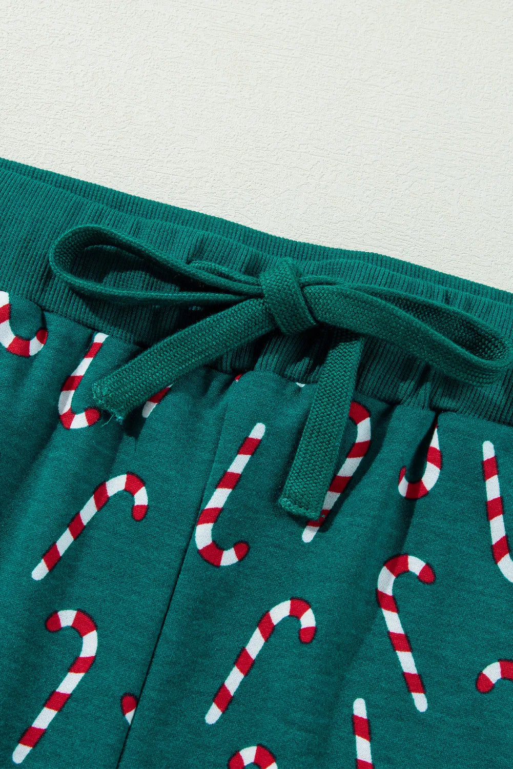 Deep Teal pajama pants with a candy cane print and drawstring waist.