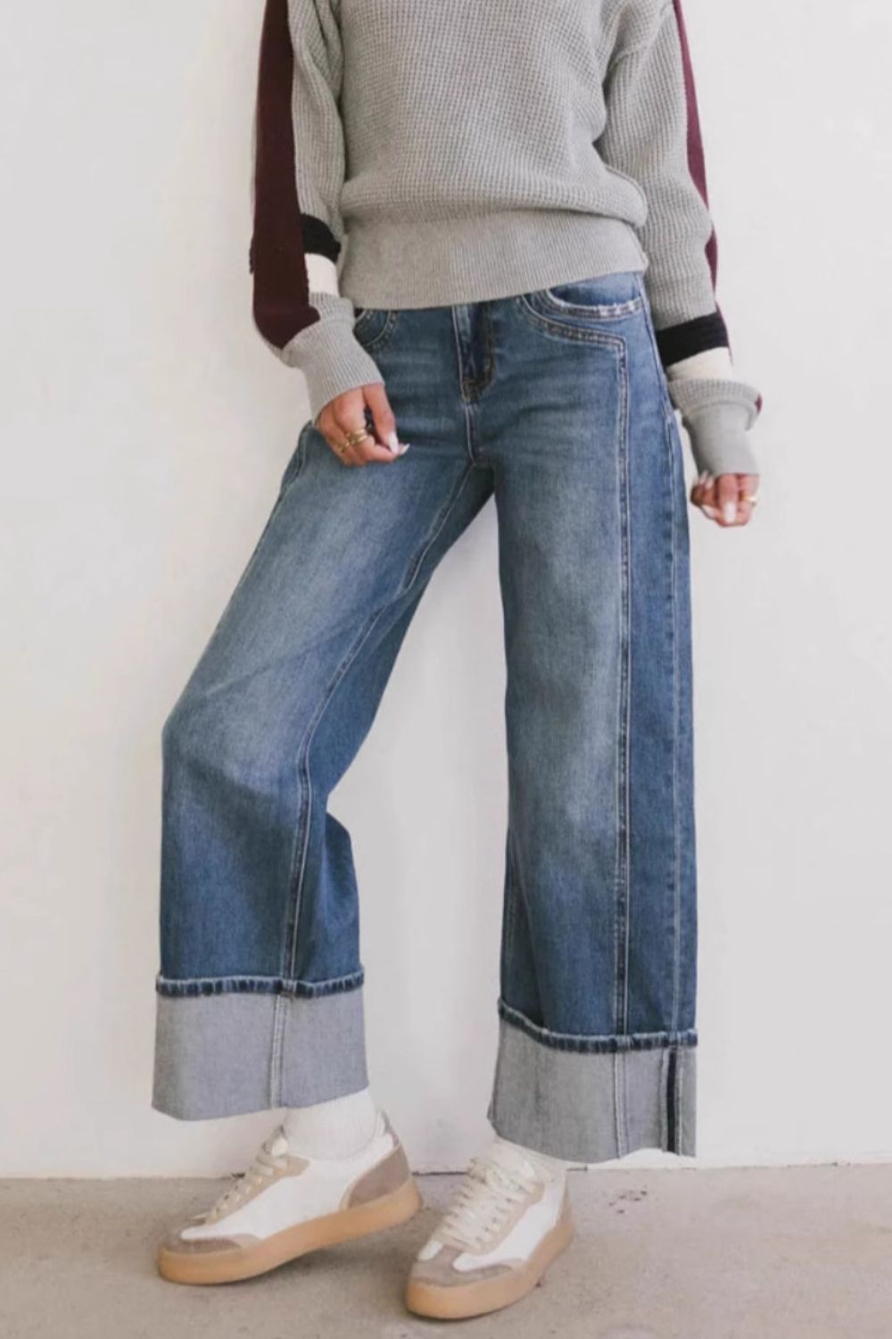 Wide-leg denim jeans in medium wash with large contrast cuffs.