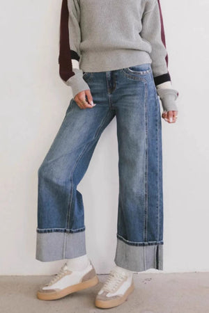 Wide-leg denim jeans in medium wash with large contrast cuffs.