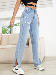 Light wash denim jeans with distressed details and slit hems.
