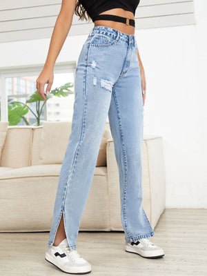 Light wash denim jeans with distressed details and slit hems.