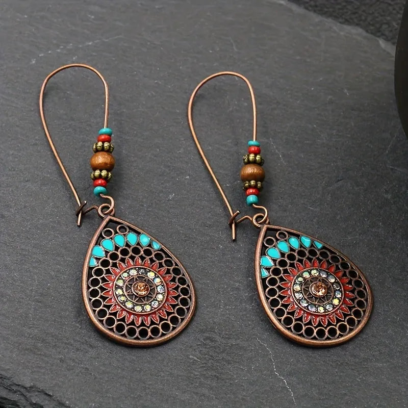 Bohemian mandala drop earrings in copper with turquoise and red accents.