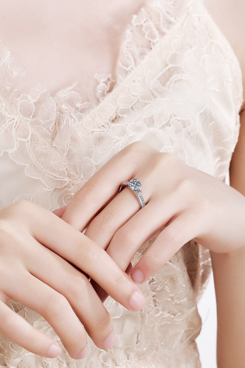 Silver rhodium engagement ring with pavé band and solitaire diamond.