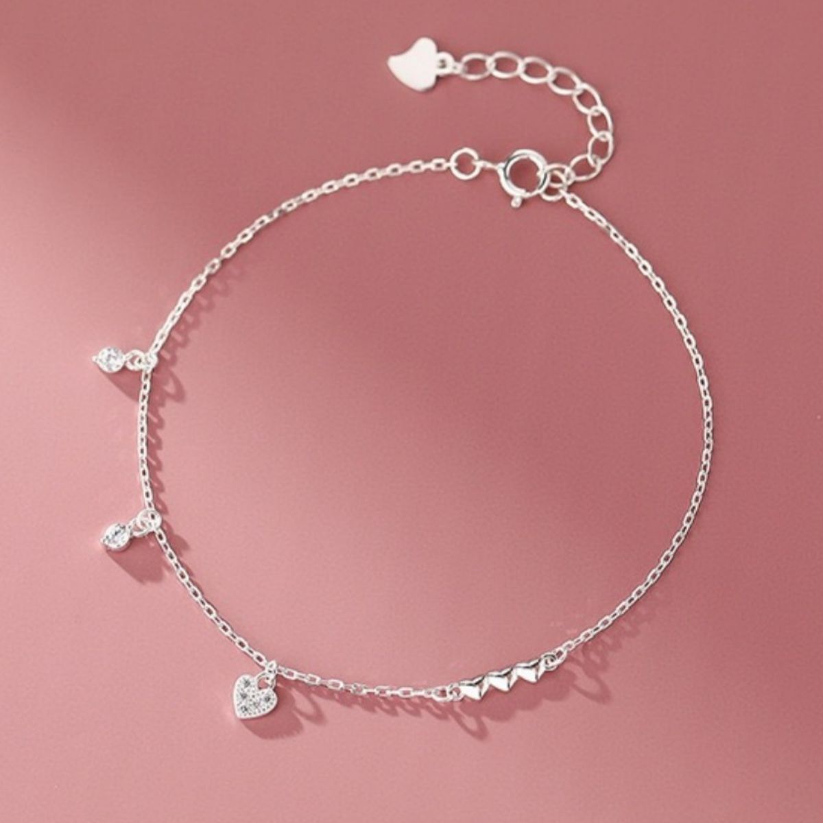 Silver sterling bracelet with delicate chain, pavé heart charm, and sparkling cubic zirconia accents.