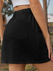 Black utility pocket mini skirt with elastic waist and buttoned details.