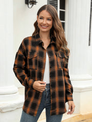 Plaid button-up shirt in brown and black with two chest pockets.