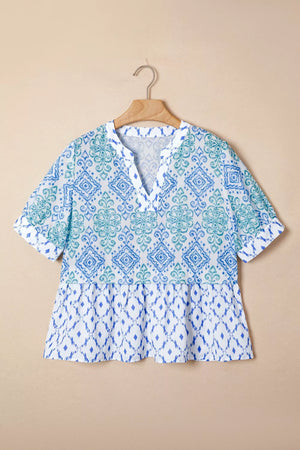 Patchwork babydoll shirt with puff sleeves, v-neck, and tiered hem in blue and green ikat print.