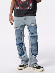 Men's light wash distressed patchwork jeans with ripped details and layered panels.