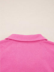 Hot pink collared pullover with raglan sleeves and a classic collar detail.